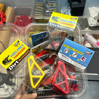 Packaged dirt bike accessories with 'Dirt' branding on a blurred background