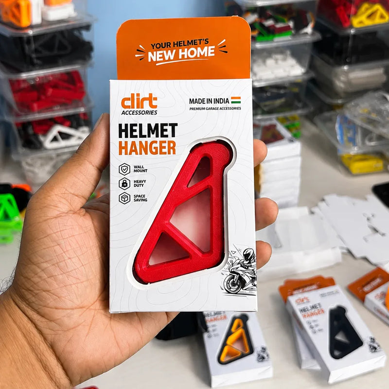 Dirt Accessories red helmet hanger shown in premium retail packaging, designed for wall-mounted helmet storage.
