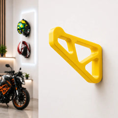 Dirt Accessories multi-color edition helmet hanger mounted on a garage wall, with blue accents and motorcycle helmets displayed in the background.