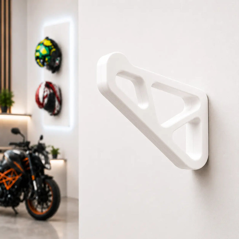Dirt Accessories multi-color edition helmet hanger mounted on a garage wall, with blue accents and motorcycle helmets displayed in the background.