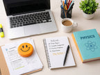 Laptop, coffee cup, notebook, and books on a desk with a plant and stationery items.